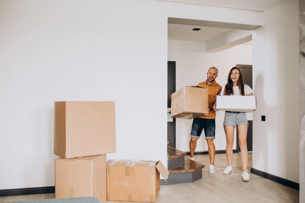 young-family-moving-into-their-new-house-boxes-room-undecorated