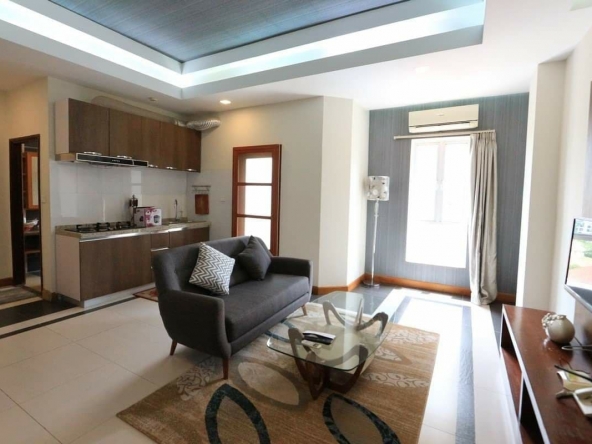 the living room and the kitchen of the 1-bedroom spacious luxury serviced apartment for rent in BKK1 in Phnom Penh Cambodia