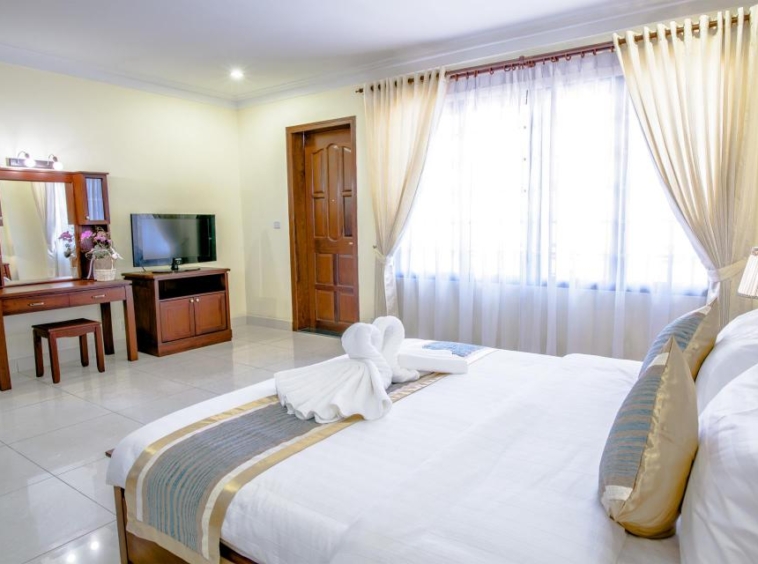 a bedroom of the 2-bedroom luxury serviced apartment for rent in BKK1 Phnom Penh Cambodia