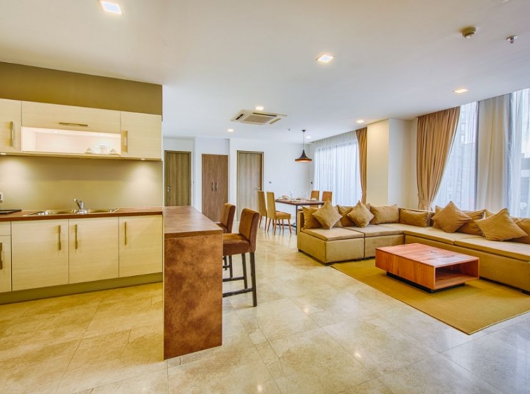 the livingroom and the kitchen of the 2-bedroom spacious luxury serviced apartment for rent in BKK1 in Phnom Penh Cambodia