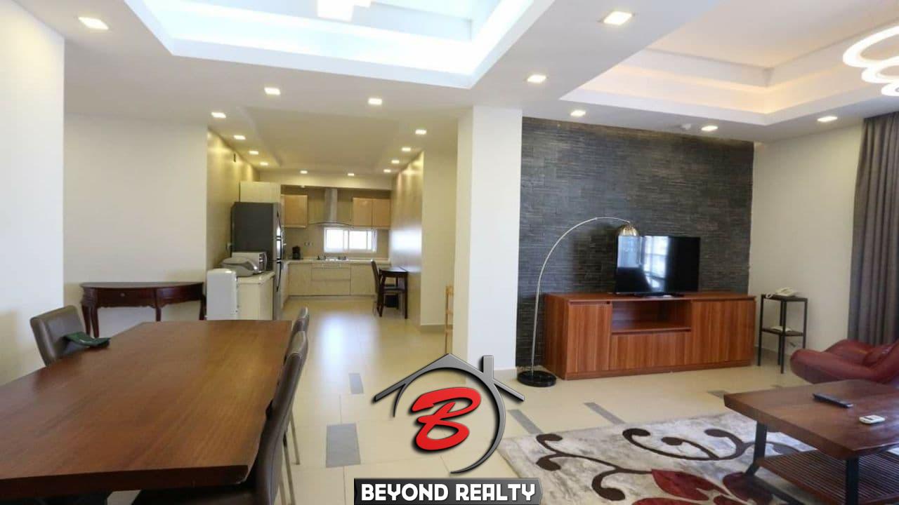 the living room and the kitchen of the 3-bedroom luxury serviced apartment for rent in BKK1 in Phnom Penh Cambodia