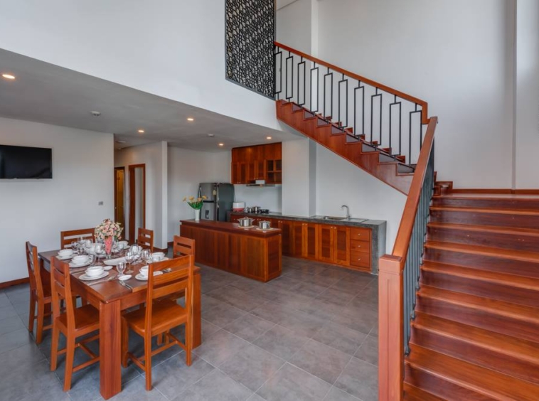 the kitchen and the stairs of the 4-bedroom duplex penthouse for rent in BKK1 in Phnom Penh Cambodia