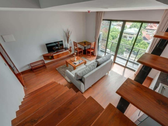 the living room of the 1-bedroom duplex loft serviced apartment for rent in BKK1 in Phnom Penh Cambodia