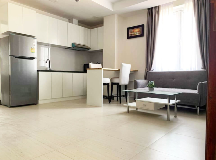 the living room and the kitchen of the 1-bedroom serviced apartment for rent in Toul Tom Poung in Phnom Penh