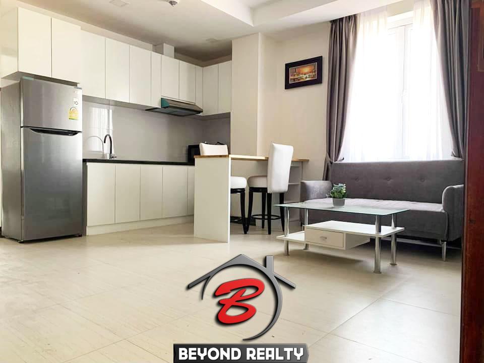 the living room and the kitchen of the 1-bedroom serviced apartment for rent in Toul Tom Poung in Phnom Penh