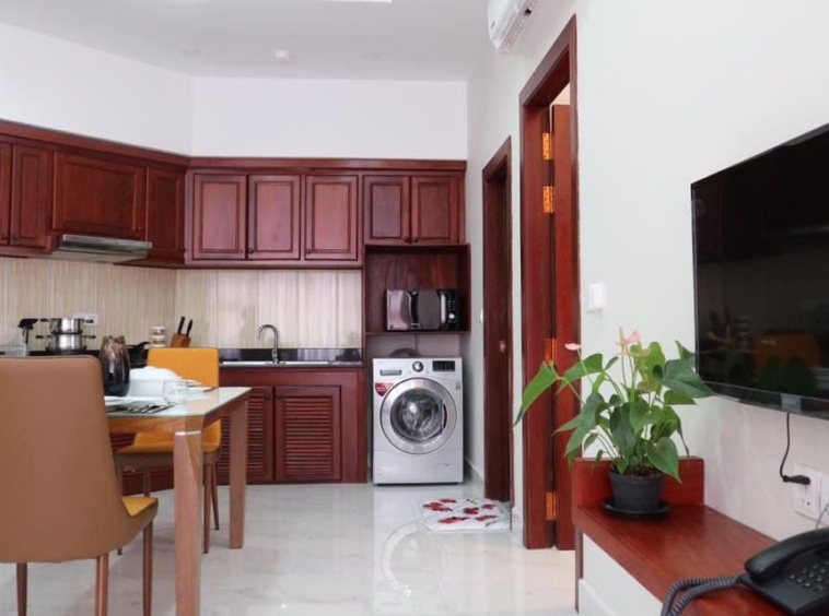the living room and the kitchen of the 1br serviced apartment for rent in Toul Tom Poung Russian Market Phnom Penh
