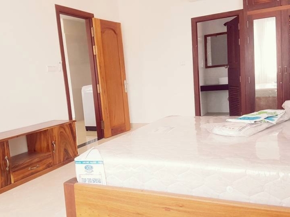 a bedroom of the 2-bedroom spacious serviced apartment rental in Toul Tom Poung