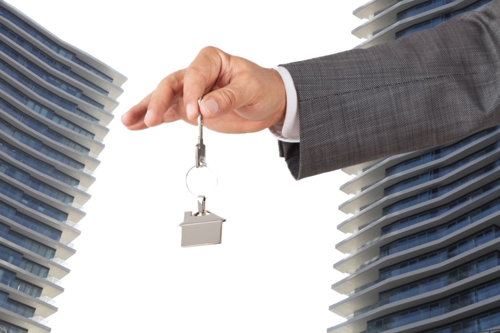 real estate services businessman holding a key