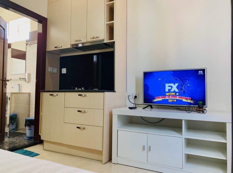 the tv and kitchen of the studio serviced apartment for rent in BKK2 in Phnom Penh Cambodia