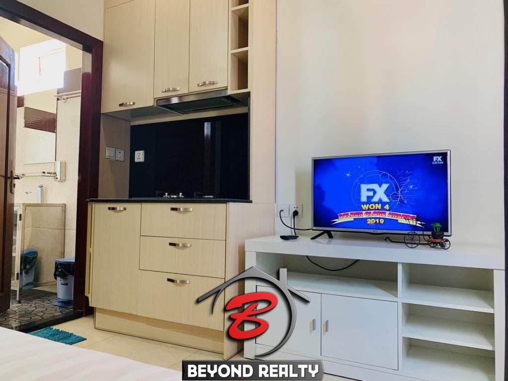 the tv and kitchen of the studio serviced apartment for rent in BKK2 in Phnom Penh Cambodia